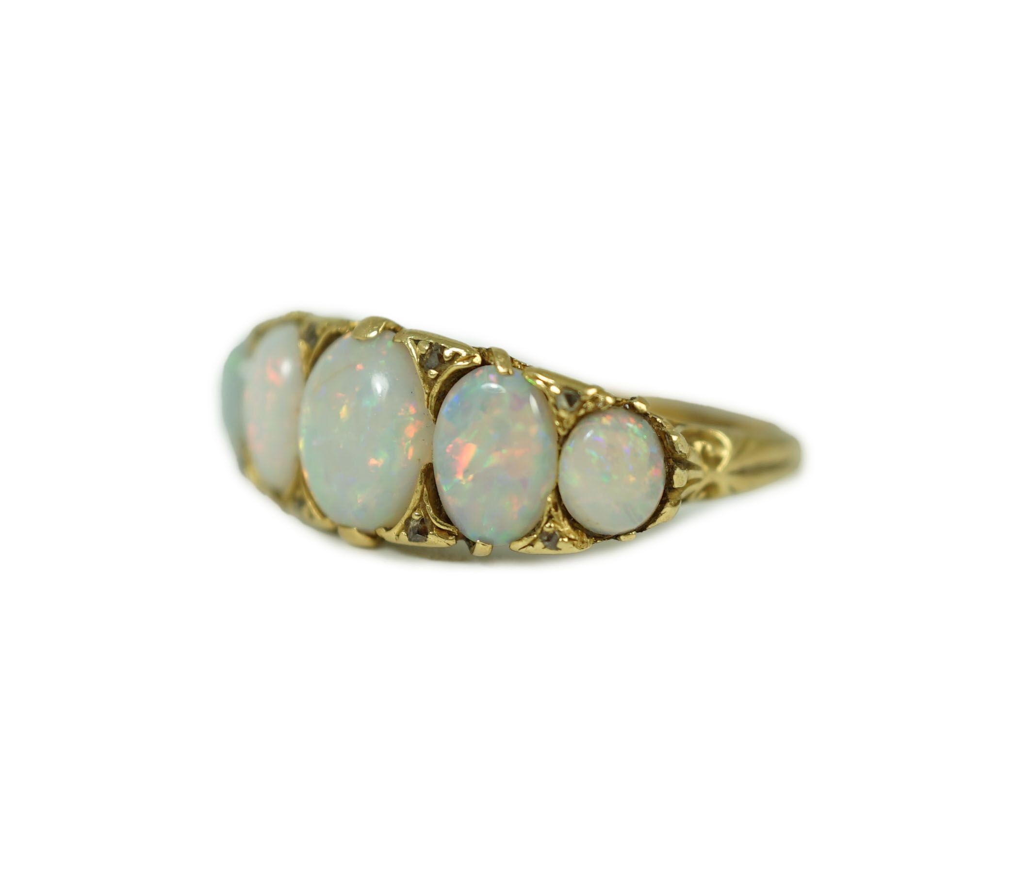 An 18ct gold and graduated five stone opal half hoop ring, with diamond chip spacers